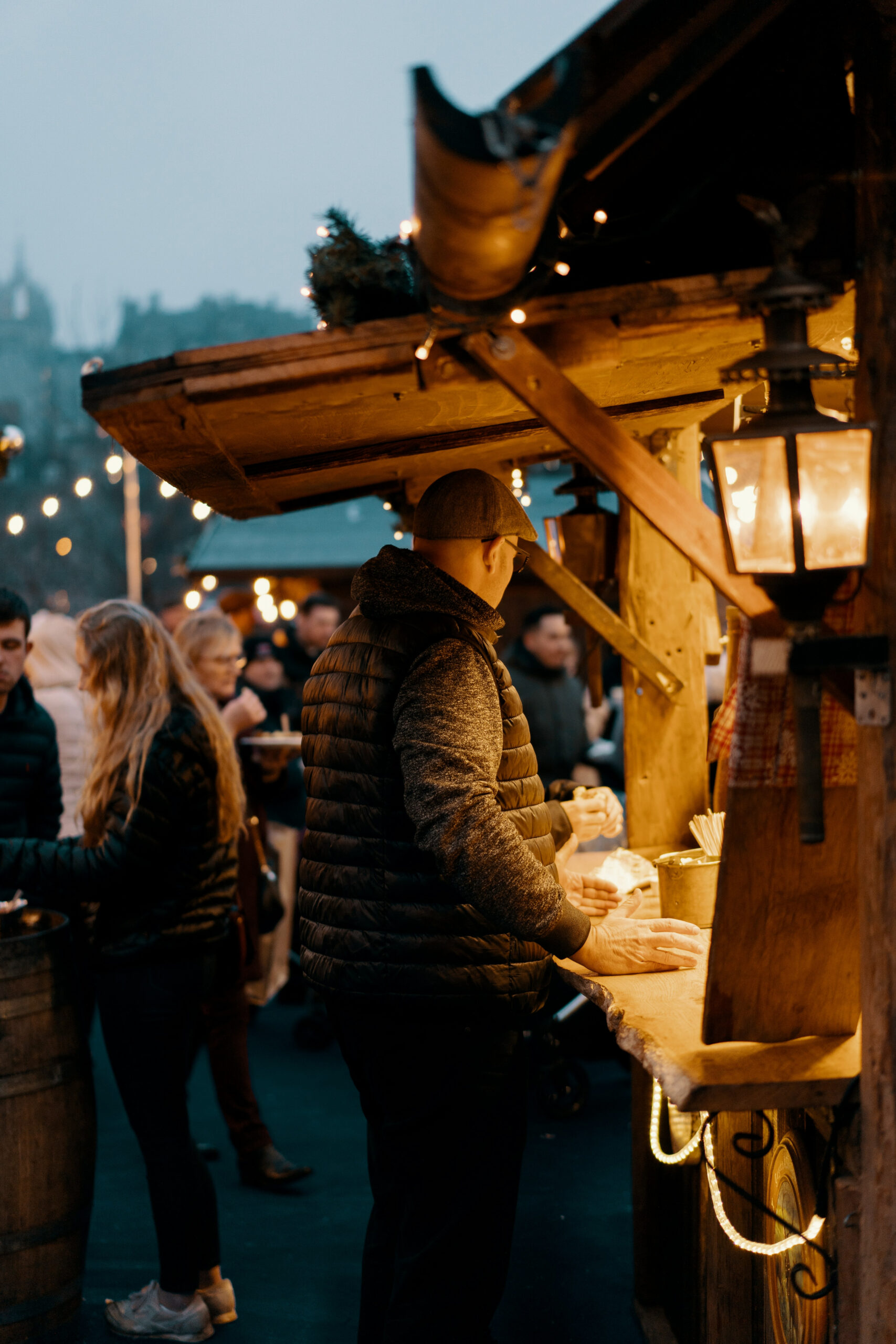 Things to do in East Cambridgeshire - Ely Market - image of man looking into wooden market stall