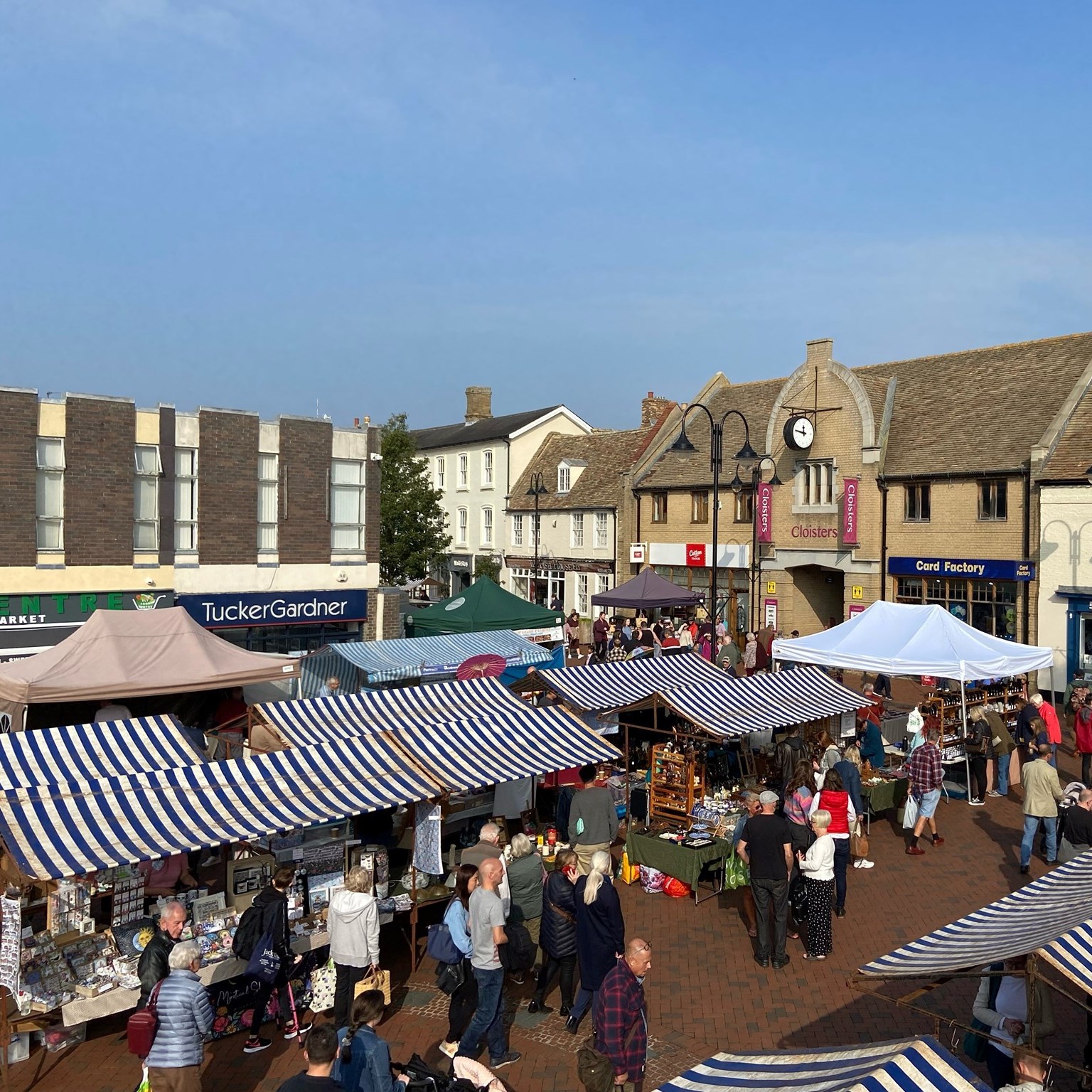 Things to do in East Cambridgeshire - Families. Ely Market stalls with shoppers from above
