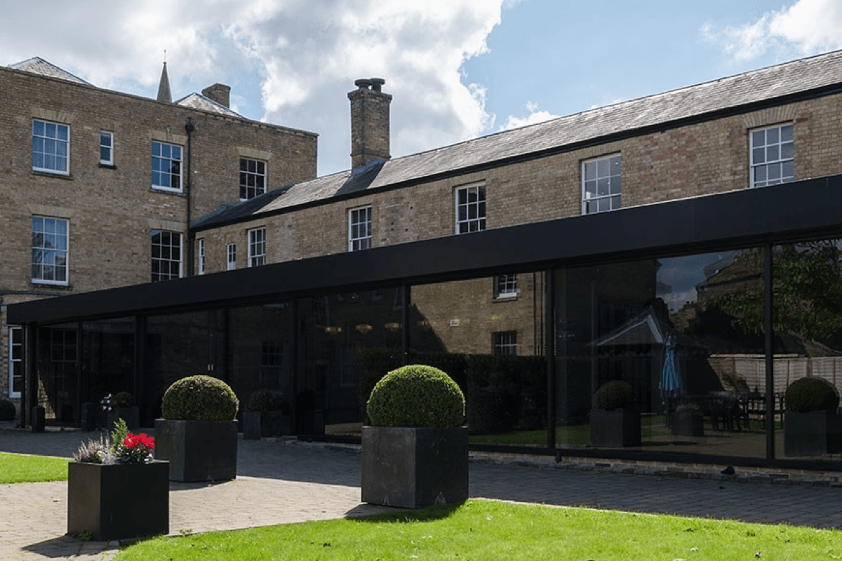 Places to stay in East Cambridgeshire - The Poets House. Photo of exterior of brick building with large windows and garden.